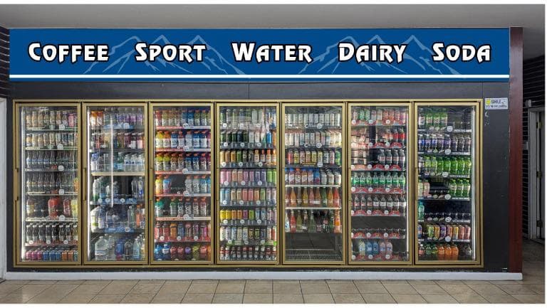 Eagle Mart beverage wall with Coffee, Sport, Water, Dairy, Soda signage